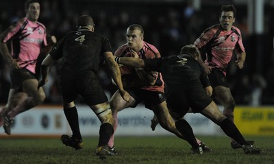 10.03.11 - Pontypridd v Neath - Principality Premiership - Kristian Dacey of Pontypridd is tackled by Euros Evans and Gerwyn Price of Neath. 