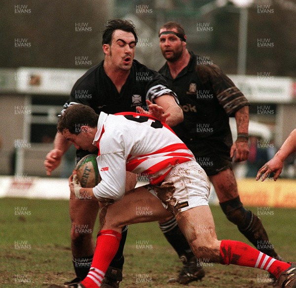 110395 - Pontypridd v Neath - Paul John of Pontypridd is tackled by Chris Scott of Neath