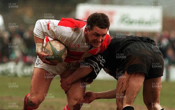 110395 - Pontypridd v Neath - Steele Lewis of Pontypridd is tackled by Chris Higgs