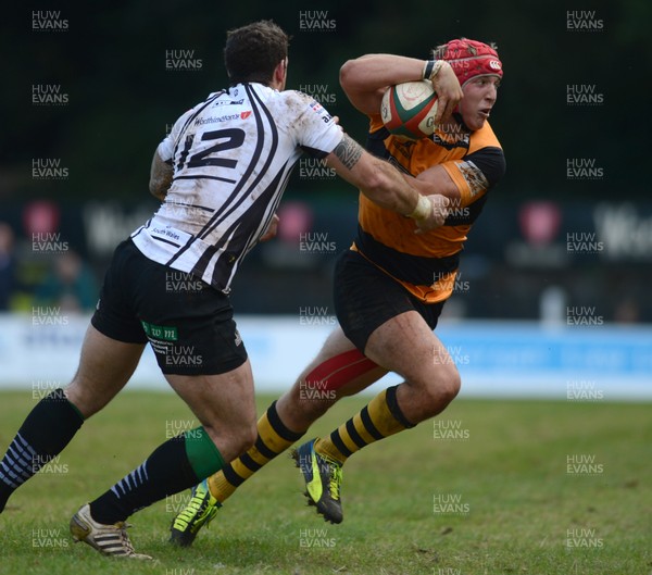 290913 - Pontypridd v Newport - Principality Premiership -Tyler Morgan of Newport is tackled by Dafydd Lockyer of Pontypridd