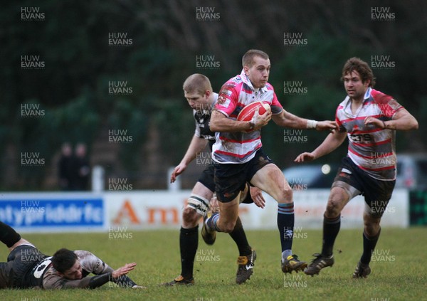 15.01.11 Pontypridd RFC v Rotherham Titans RFC - British & Irish Cup - Rotherham's Pete Swatkins bursts through the tackle of Pontypridd's Dean Gunter. 