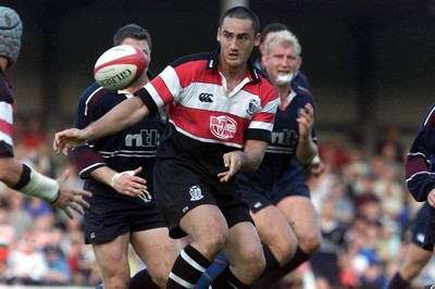 260800 - Pontypridd v Swansea - Pontypridd's Sonny Parker feeds the ball out as Ponty go on the attack