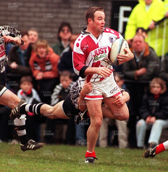 050497 - Pontypridd v Treorchy - David Manley of Pontypridd is tackled by David Lloyd