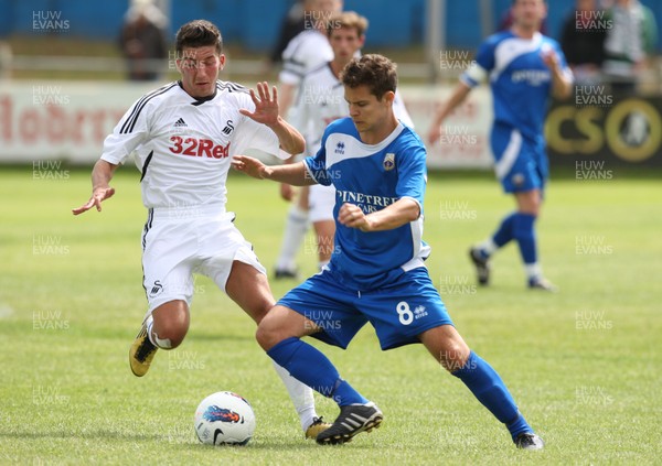 16.07.11 - Port Talbot v Swansea City, pre-season friendly -  Port Talbot 's Matthew Thompson is challenged by Swansea's Lee Lucas 