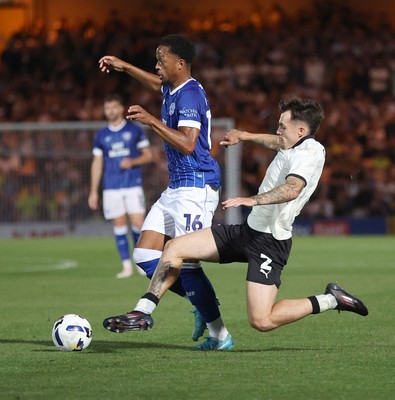 070825 - Port Vale v Cardiff City - Sky Bet League 1 - Chris Willock of Cardiff is tackled by Mitch Clark of Port Vale