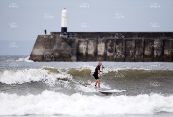220620 - Picture shows a paddle boarder on the coast at Porthcawl on Monday morning, with temperatures set to sore later this week
