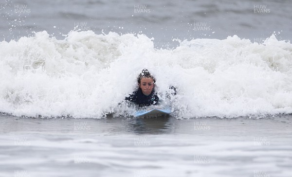 220620 - Picture shows a surfer on the coast at Porthcawl on Monday morning, with temperatures set to sore later this week