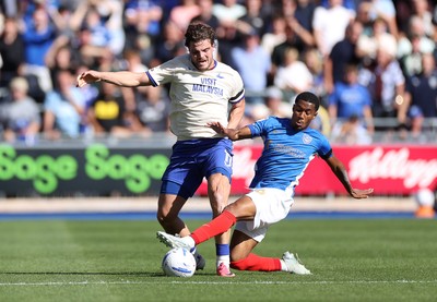 050926 - Portsmouth FC v Cardiff City - SkyBet Championship - Ollie Tanner of Cardiff City is tackled by Luke Le Roux of Portsmouth 