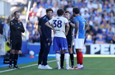 050926 - Portsmouth FC v Cardiff City - SkyBet Championship - Referee Ben Speedie speaks to both managers Brian Barry-Murphy and John Mousinho along with captains Perry Ng of Cardiff City and Marlon Pack of Portsmouth 