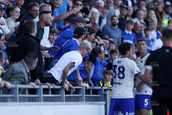 050926 - Portsmouth FC v Cardiff City - SkyBet Championship - Perry Ng pulls Krystian Bielik of Cardiff City away from the crowd