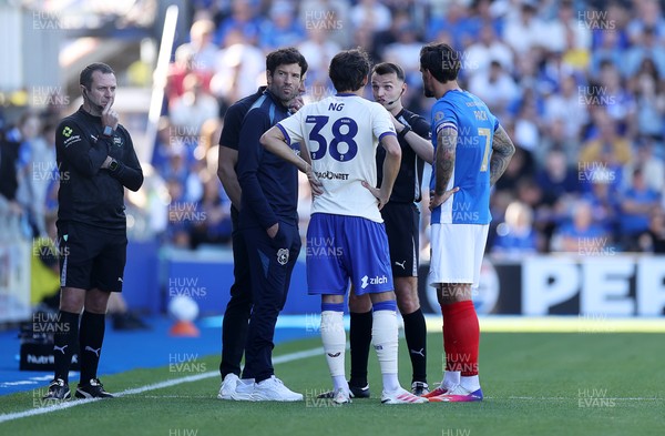 050926 - Portsmouth FC v Cardiff City - SkyBet Championship - Referee Ben Speedie speaks to both managers Brian Barry-Murphy and John Mousinho along with captains Perry Ng of Cardiff City and Marlon Pack of Portsmouth 