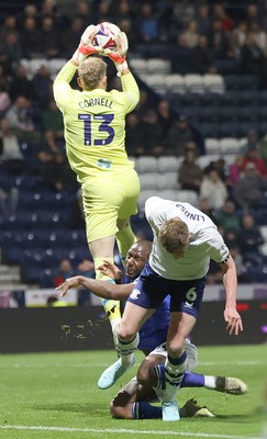 080425 - Preston North End v Cardiff City - Sky Bet Championship - Yakou Meite of Cardiff falls into Goalkeeper David Cornell of Preston North End with Liam Lindsay of Preston North End