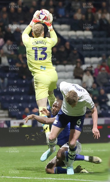 080425 - Preston North End v Cardiff City - Sky Bet Championship - Yakou Meite of Cardiff falls into Goalkeeper David Cornell of Preston North End with Liam Lindsay of Preston North End