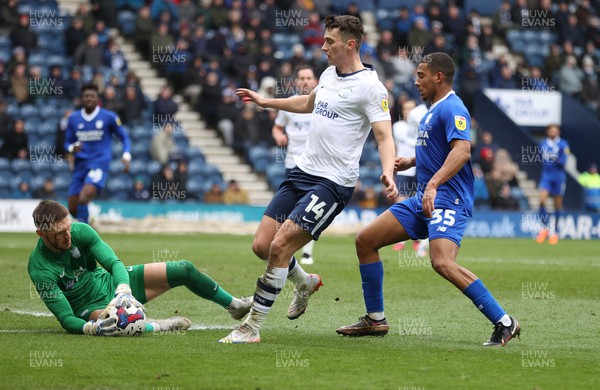 110323 - Preston North End v Cardiff City - Sky Bet Championship - Goalkeeper Freddie Woodman of Preston North End saves from the feet of Andy Rinomhota of Cardiff