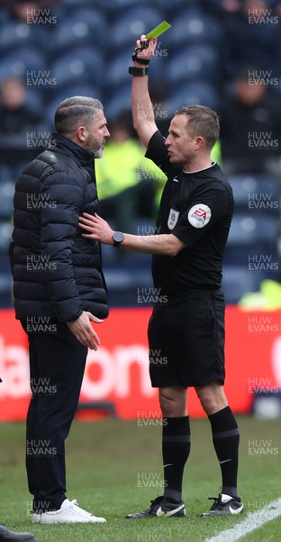 110323 - Preston North End v Cardiff City - Sky Bet Championship - Manager Ryan Lowe of Preston North End gets a yellow card from referee David Webb for kicking the first aid box