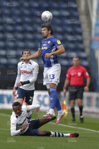 270620 - Preston North End v Cardiff City - Sky Bet Championship - Callum Paterson of Cardiff reaches the ball instead of a floored Darnell Fisher of Preston North End