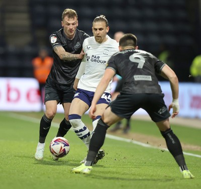 040325 - Preston North End v Swansea City - Sky Bet Championship - Brad Potts of Preston North End is stopped by Josh Tymon of Swansea and Zan Vipotnik of Swansea