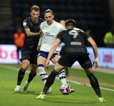 040325 - Preston North End v Swansea City - Sky Bet Championship - Brad Potts of Preston North End is stopped by Josh Tymon of Swansea and Zan Vipotnik of Swansea