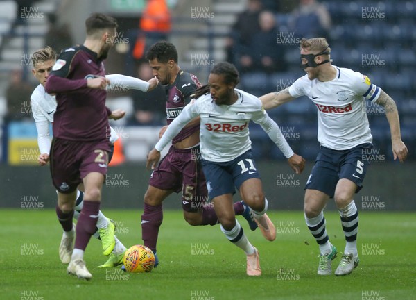 120119 - Preston North End v Swansea City - Sky Bet Championship -  Wayne Routledge of Swansea is tackled by Daniel Johnson of Preston North End and Tom Clarke of Preston North End  