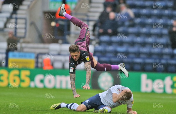 120119 - Preston North End v Swansea City - Sky Bet Championship - Matt Gimes of Swansea leaps over Jayden Stockley of Preston North End to clear   