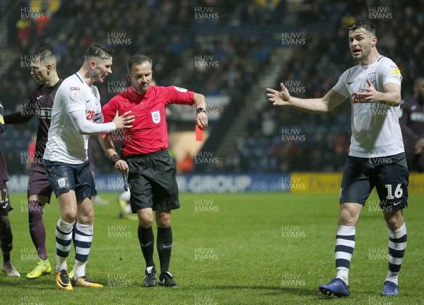 120119 - Preston North End v Swansea City - Sky Bet Championship - Referee KStroud gives a red card to Josh Earl of Preston North End (not pictured) whilst Andrew Hughes and Alan Browne of Preston North End protest    