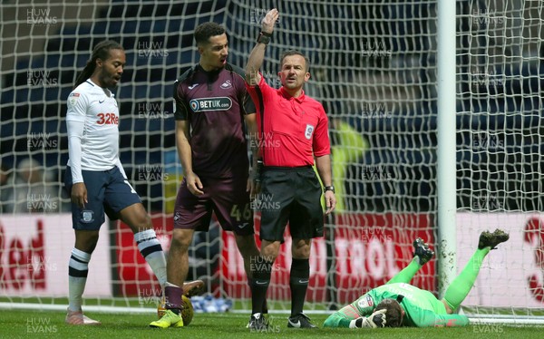 120119 - Preston North End v Swansea City - Sky Bet Championship - Courtney Baker-Richardson  of Swansea is told off by the Referee KStroud for flooring goalkeeper Declan Rudd of Preston North End  