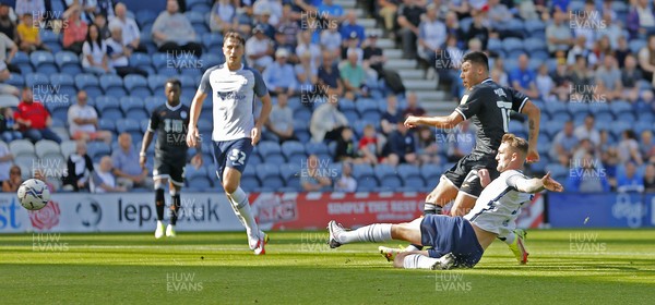 280821 - Preston North End v Swansea City - Sky Bet Championship - Joel Piroe of Swansea scores the 1st goal of the match despite the efforts of Patrick Bauer of Preston North End