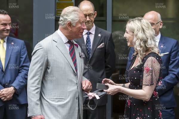 010719 - The Prince's Trust - Picture shows HRH Prince Charles visiting Connect Assist in Nantgarw, South Wales - The Prince of Wales is presented by cufflinks by by Mari Thomas who was helped by the Trust 20 years ago