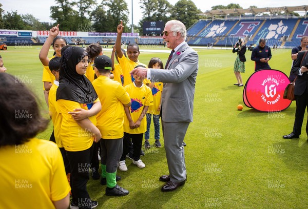 090721 - Prince Charles, the Prince of Wales meets school children during his visit to Glamorgan County Crickets ground Sophia Gardens in Cardiff this morning