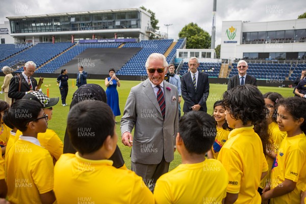 090721 - Prince Charles, the Prince of Wales meets school children during his visit to Glamorgan County Crickets ground Sophia Gardens in Cardiff this morning