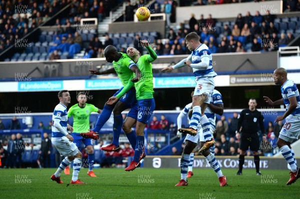 010118 - Queens Park Rangers v Cardiff City - Sky Bet Championship - Souleymane Bamba and Matthew Connolly of Cardiff City compete in the air with Jake Bidwell of QPR