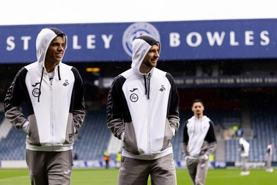 241026 - Queens Park Rangers v Swansea City - Sky Bet Championship - Tom Iorpenda and Žan Vipotnik of Swansea City walk on the pitch prior to the game