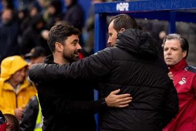 241026 - Queens Park Rangers v Swansea City - Sky Bet Championship - V�tor Matos, Manager of Swansea City, hugs Julien St�phan manager of Queens Park Rangers