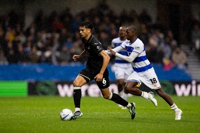 241026 - Queens Park Rangers v Swansea City - Sky Bet Championship - Marko Stamenic of Swansea City is challenged by Glen Kamara of Queens Park Rangers