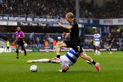 241026 - Queens Park Rangers v Swansea City - Sky Bet Championship - Melker Widell of Swansea City is challenged by Kealey Adamson of Queens Park Rangers