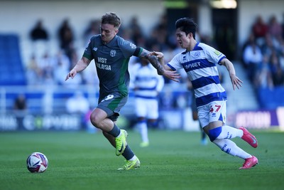 050425 - Queens Park Rangers v Cardiff City - Sky Bet Championship - Isaak Davies of Cardiff City is challenged by Yang Min-Hyeok of Queens Park Rangers