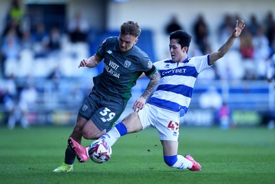 050425 - Queens Park Rangers v Cardiff City - Sky Bet Championship - Isaak Davies of Cardiff City is challenged by Yang Min-Hyeok of Queens Park Rangers