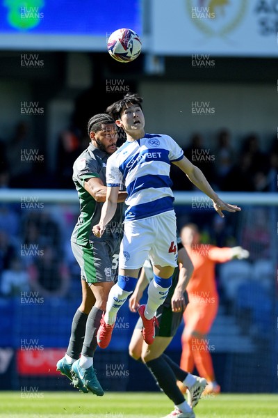 050425 - Queens Park Rangers v Cardiff City - Sky Bet Championship - Andy Rinomhota of Cardiff City is challenged by Yang Min-Hyeok of Queens Park Rangers