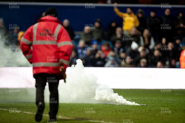 210123 - Queens Park Rangers v Swansea City - Sky Bet Championship - Fire marshal walks on to pick up a flare