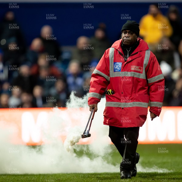 210123 - Queens Park Rangers v Swansea City - Sky Bet Championship - Fire marshal walks on to pick up a flare