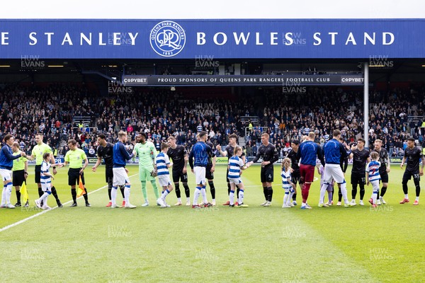 210425 - Queens Park Rangers v Swansea City - Sky Bet Championship - Players of Swansea city and Queens Park Rangers greet each other prior to the game