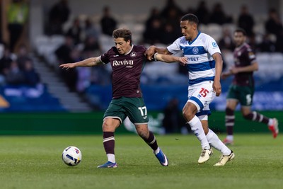 210426 - Queens Park Rangers v Swansea City - Sky Bet Championship - Goncalo Franco of Swansea City is challenged by Isaac Hayden of Queens Park Rangers
