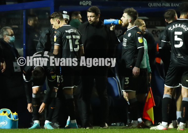 250122 - Queens Park Rangers v Swansea City, Sky Bet Championship - Swansea City head coach Russell Martin speak to his players during a break in play
