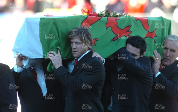 15.11.07 - Ray Gravell Funeral - (L-R)Simon Easterby, Stephen Jones and Delme Thomas take Ray Gravell's coffin off the pitch at Stradey Park at the end of the funeral 