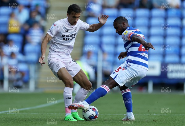 060822 - Reading v Cardiff City - SkyBet Championship - Tom Sang of Cardiff City is tackled by Junior Hoilett of Reading