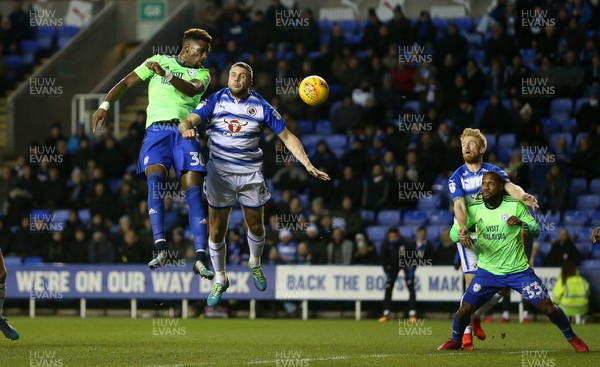 111217 - Reading v Cardiff City - SkyBet Championship - Omar Bogle of Cardiff City is challenged by Joey van den Berg of Reading as he headers the ball towards the goal