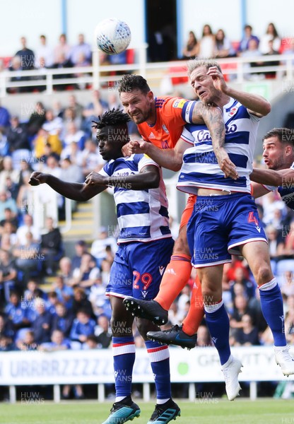 180819 - Reading v Cardiff City, Sky Bet Championship - Sean Morrison of Cardiff City  gets between Judilson Gomes of Reading and Michael Morrison of Reading as he looks to win the ball