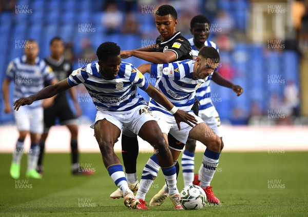 100821 - Reading v Swansea City - Carabao Cup - Morgan Whittaker of Swansea City is tackled by Nelson Abbey and Dejan Tetek of Reading