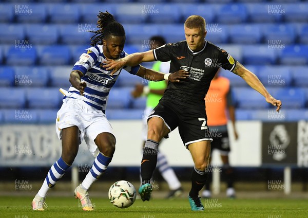 100821 - Reading v Swansea City - Carabao Cup - Jake Bidwell of Swansea City is tackled by Lynford Sackey of Reading