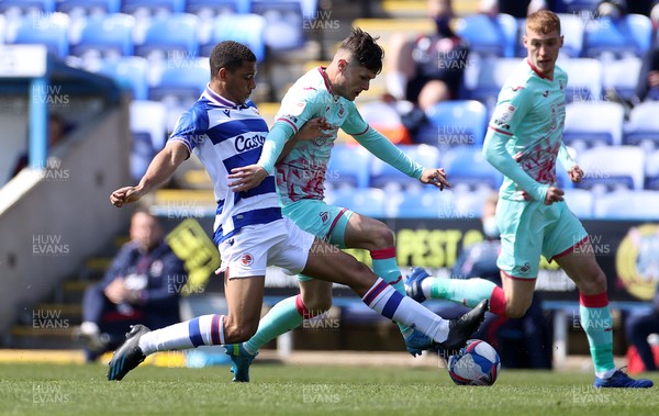 250421 - Reading v Swansea City - SkyBet Championship - Liam Cullen of Swansea City is tackled by Andy Rinomhota of Reading